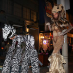 Two Stiltwalker Performers in Lion and Zebra Costume